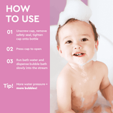Baby with bath foam and cap demonstrating bubble bath usage